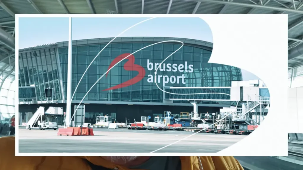 fachada do Brussels Airport com logo visível e equipamentos de pátio em primeiro plano