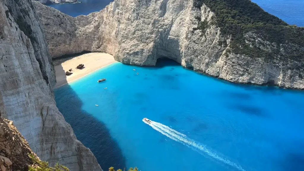 Vista aérea de Navagio Beach em Zakynthos mostrando falésias, praia e barcos
